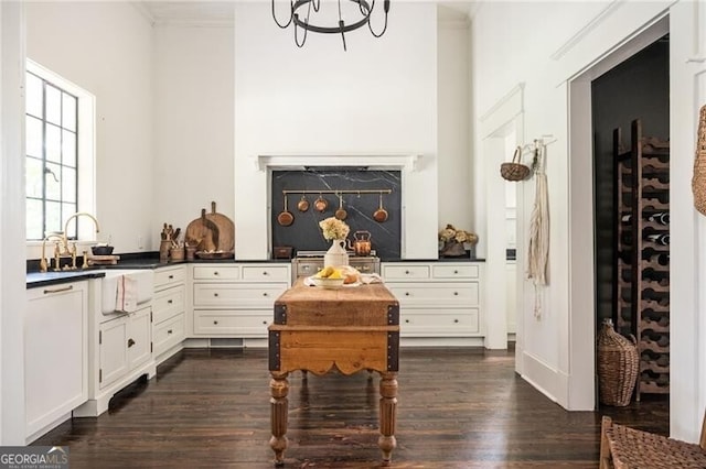 interior space featuring white cabinetry, a notable chandelier, and dark hardwood / wood-style flooring