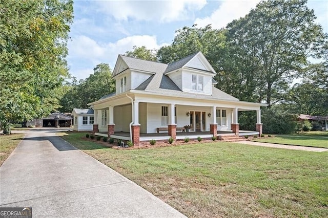 view of front of home with covered porch and a front yard