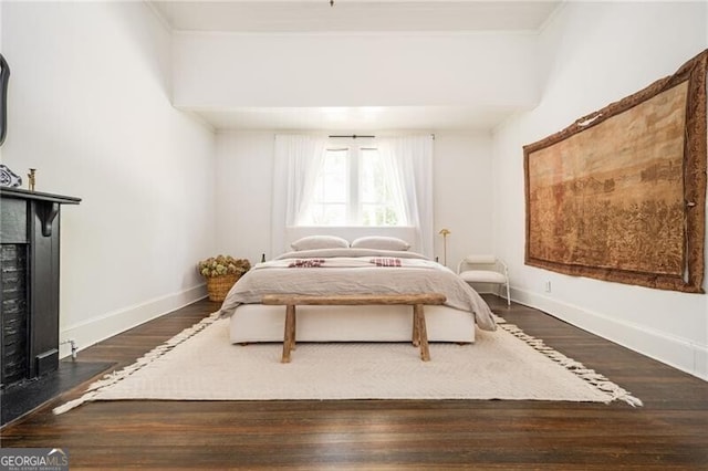 bedroom with dark hardwood / wood-style floors