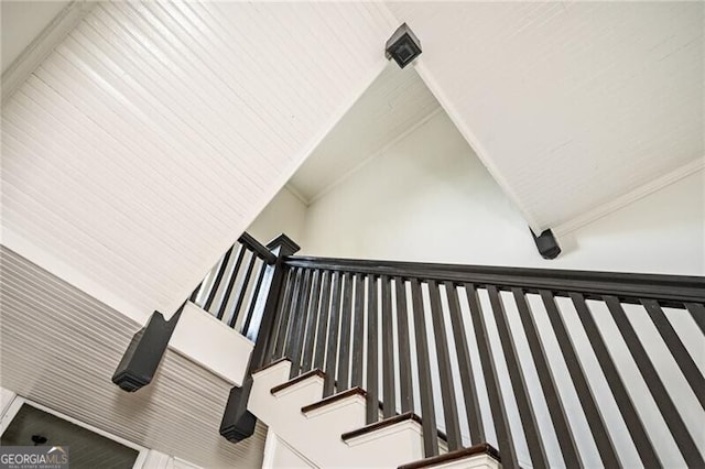 staircase featuring lofted ceiling