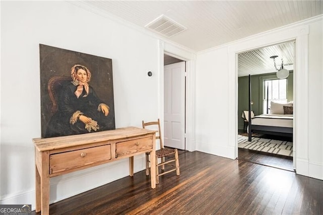 corridor with ornamental molding and dark hardwood / wood-style floors