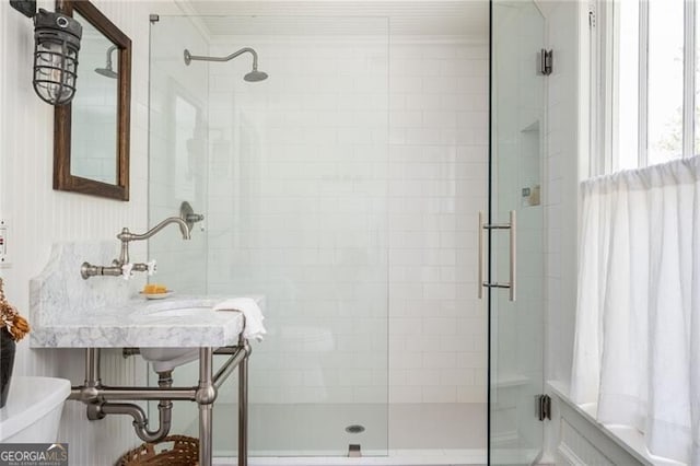 bathroom featuring an enclosed shower and toilet