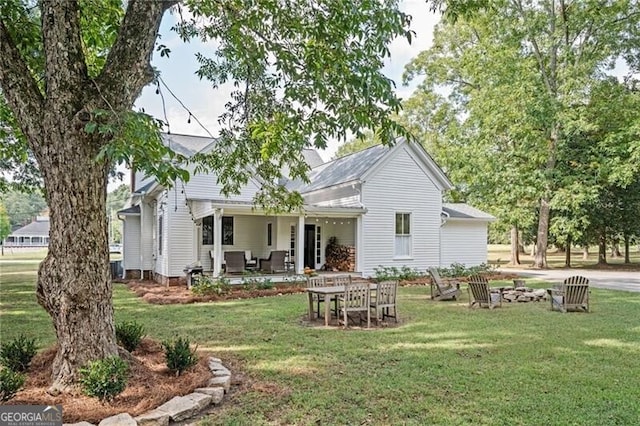 rear view of house with a yard