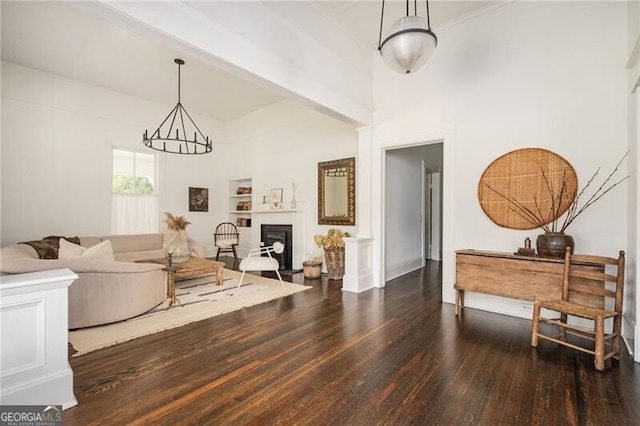 living room featuring dark hardwood / wood-style flooring and a chandelier