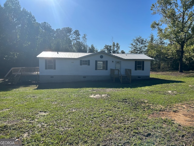 rear view of house with a yard