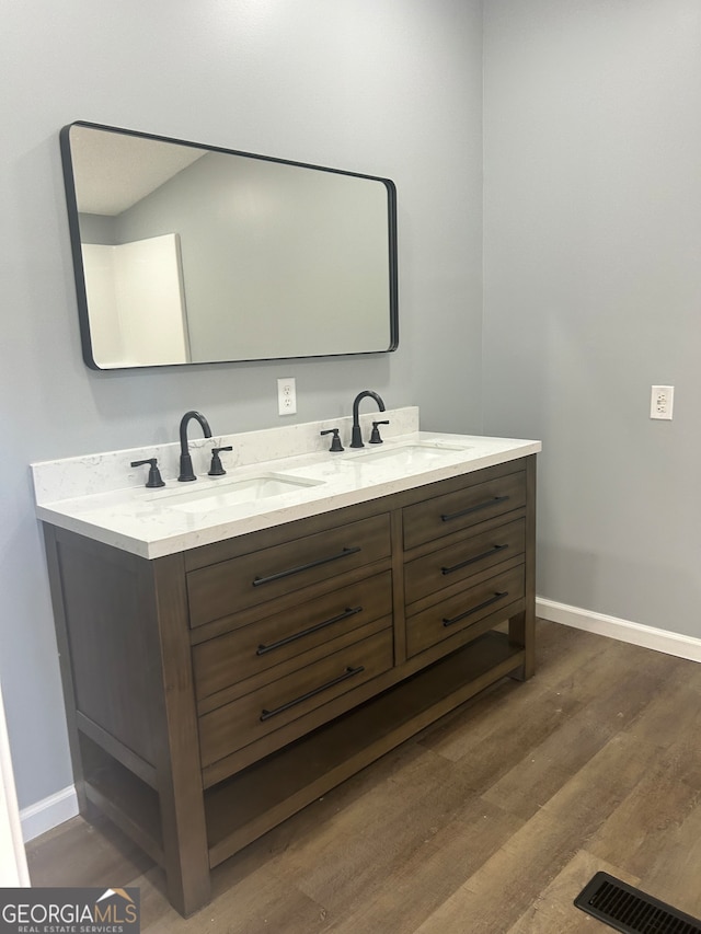 bathroom featuring hardwood / wood-style flooring and vanity