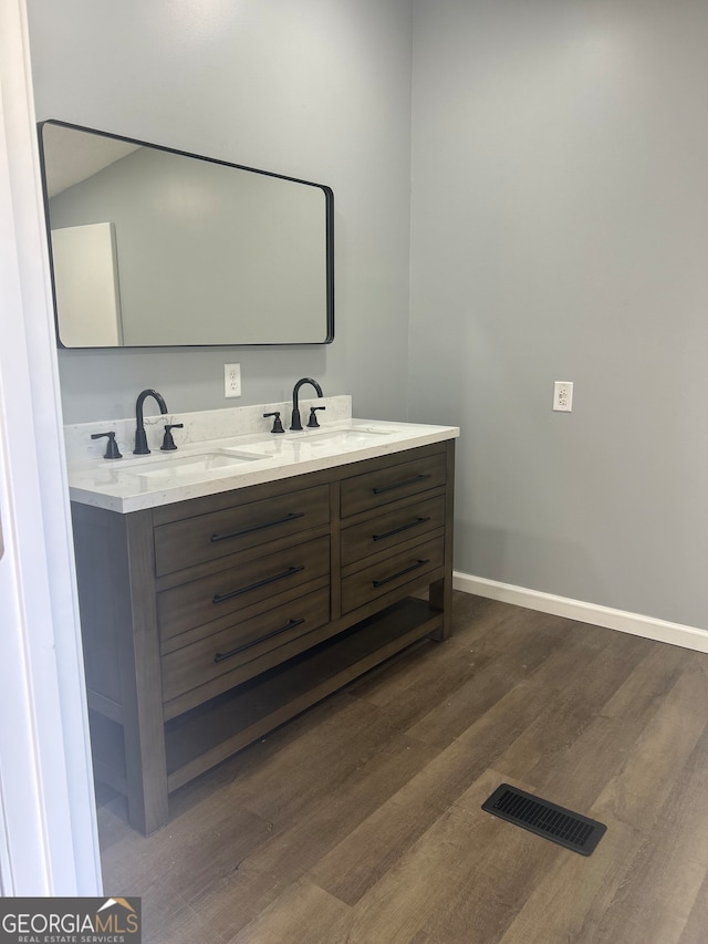 bathroom with vanity and hardwood / wood-style flooring