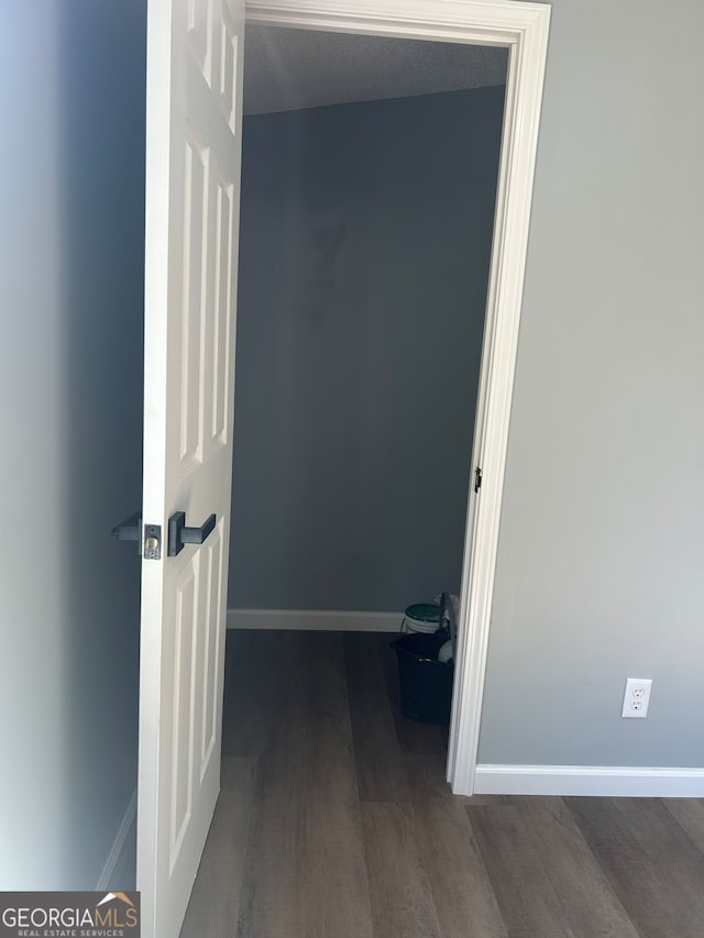 hallway with dark wood-type flooring