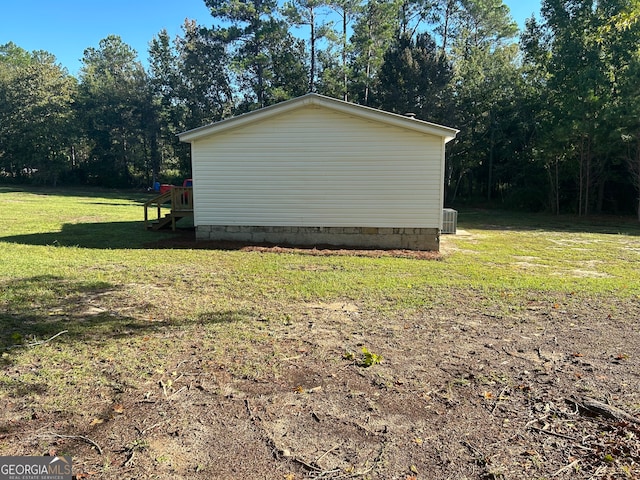 view of home's exterior with cooling unit and a yard