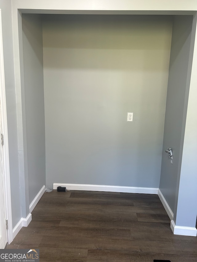 laundry area with dark hardwood / wood-style floors