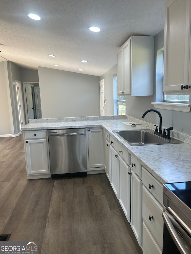 kitchen with dishwasher, kitchen peninsula, white cabinetry, and sink