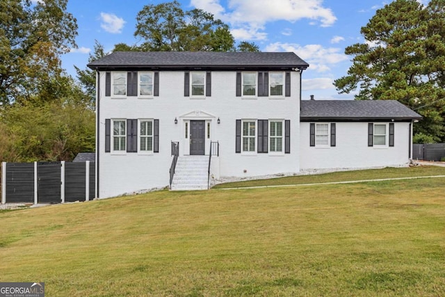 colonial inspired home featuring a front yard