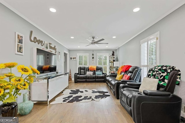 living room featuring plenty of natural light, light hardwood / wood-style floors, and ornamental molding