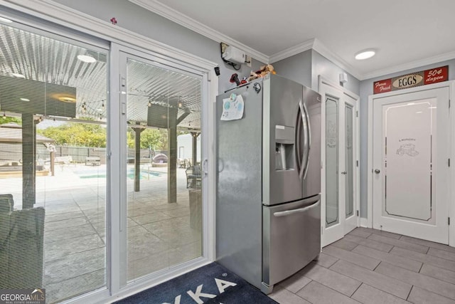 kitchen featuring stainless steel fridge and crown molding