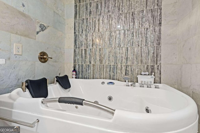 bathroom featuring tile walls and a bathing tub