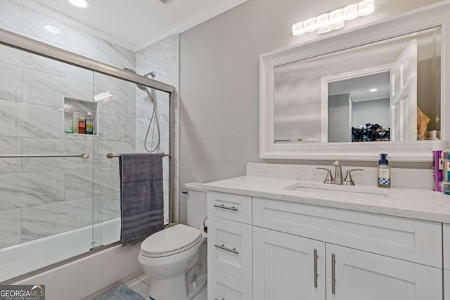 full bathroom featuring tile patterned floors, crown molding, bath / shower combo with glass door, toilet, and vanity