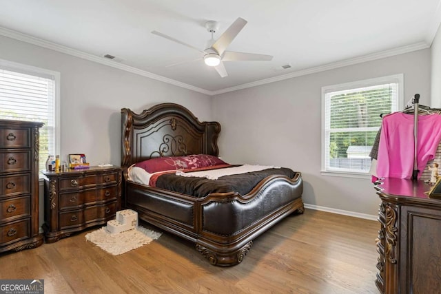 bedroom featuring light hardwood / wood-style floors, ceiling fan, and ornamental molding