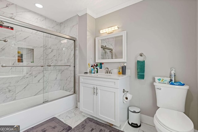 full bathroom with crown molding, vanity, bath / shower combo with glass door, and toilet