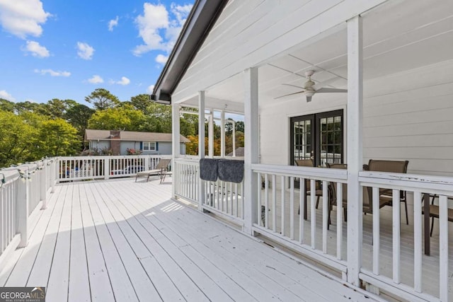 wooden deck featuring ceiling fan