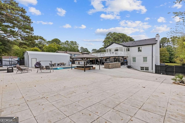 exterior space featuring a gazebo, a patio, and a fenced in pool