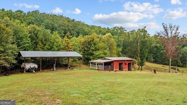 view of yard with a rural view and an outbuilding