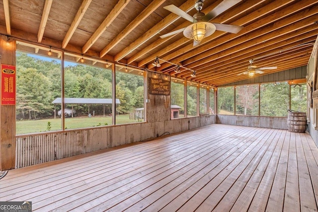 unfurnished sunroom with ceiling fan and plenty of natural light