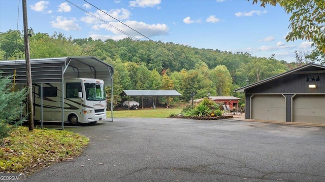 view of vehicle parking featuring a carport