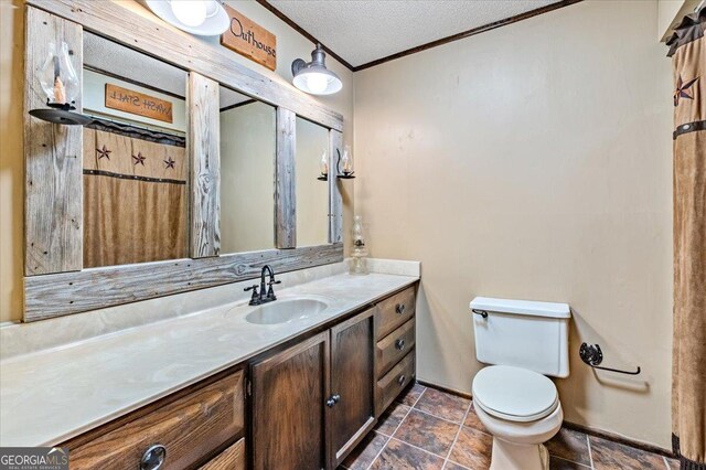 bathroom featuring vanity, a textured ceiling, toilet, and crown molding