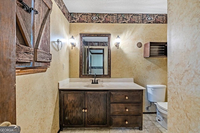 bathroom with tile patterned floors, vanity, toilet, and a textured ceiling