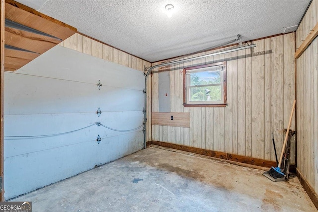 garage featuring electric panel and wooden walls