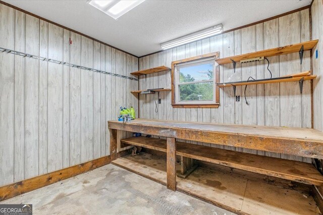 basement featuring a workshop area and wood walls