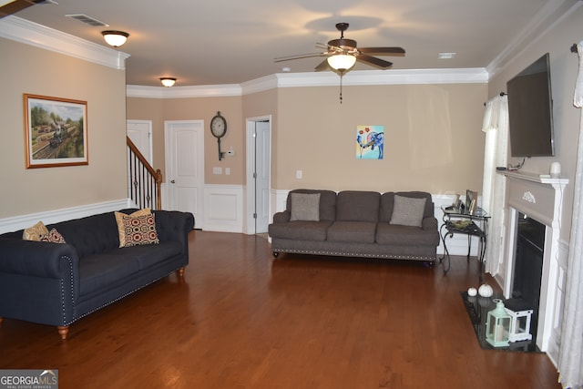 living room featuring ceiling fan, dark hardwood / wood-style floors, and crown molding