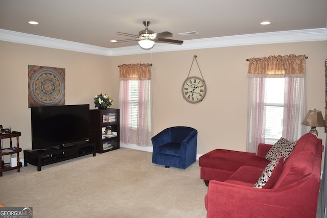 carpeted living room featuring ceiling fan and ornamental molding