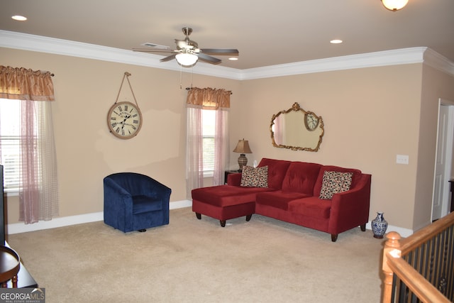 living room with ceiling fan, light colored carpet, and crown molding