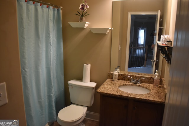 bathroom with vanity, toilet, and a shower with shower curtain