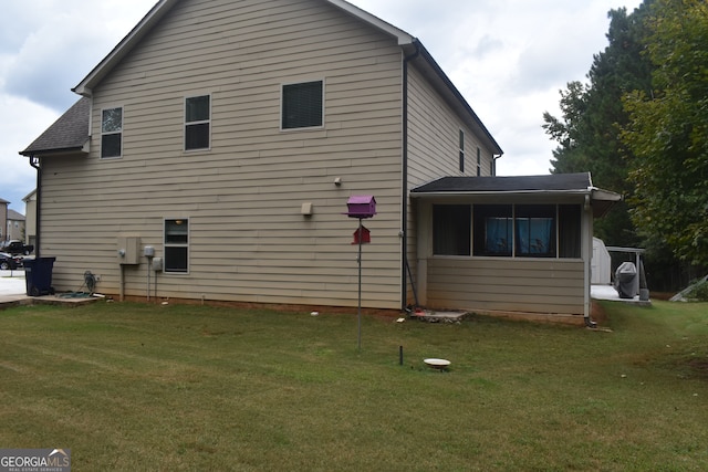 back of house with a lawn