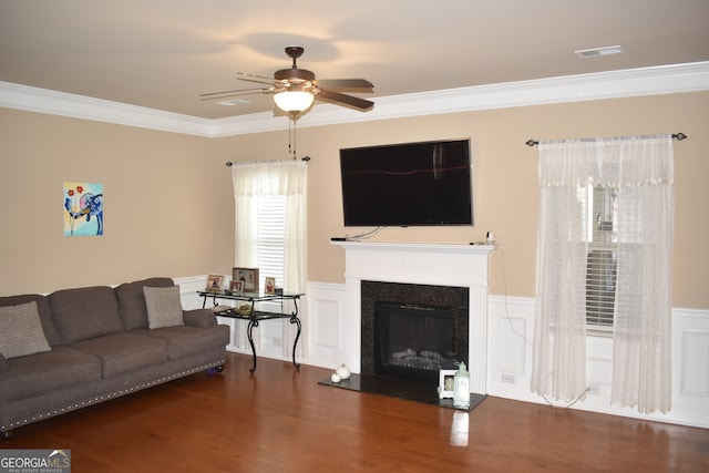 living room with crown molding, dark hardwood / wood-style floors, and ceiling fan