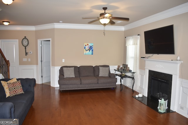 living room with ceiling fan, dark hardwood / wood-style floors, and ornamental molding