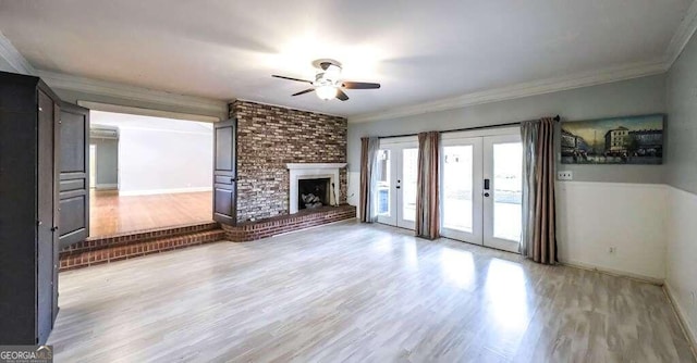 unfurnished living room featuring french doors, ceiling fan, hardwood / wood-style flooring, and a fireplace