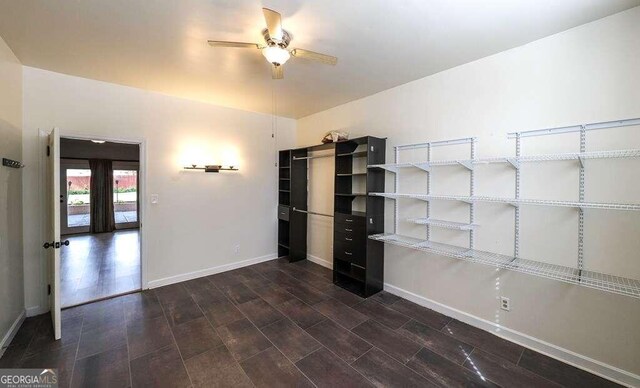 interior space with ceiling fan and dark hardwood / wood-style flooring