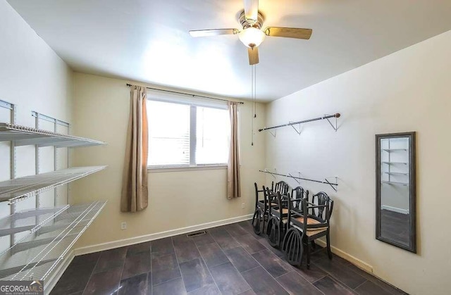 miscellaneous room with ceiling fan and dark hardwood / wood-style floors