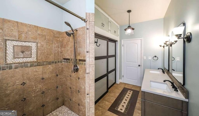 bathroom with vanity and a tile shower