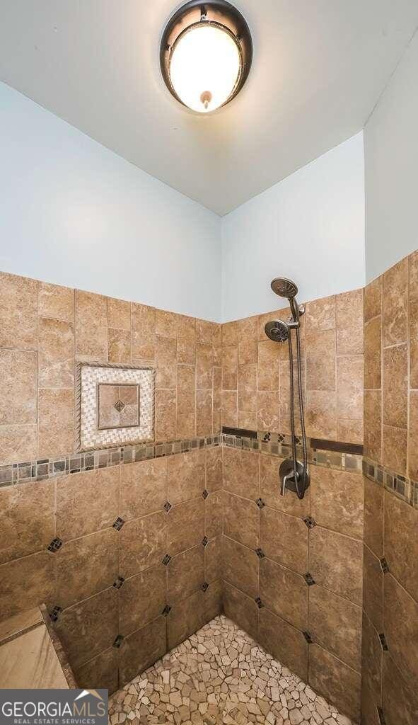 bathroom with tiled shower