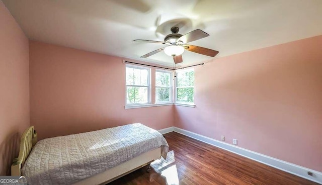 bedroom with ceiling fan and wood-type flooring