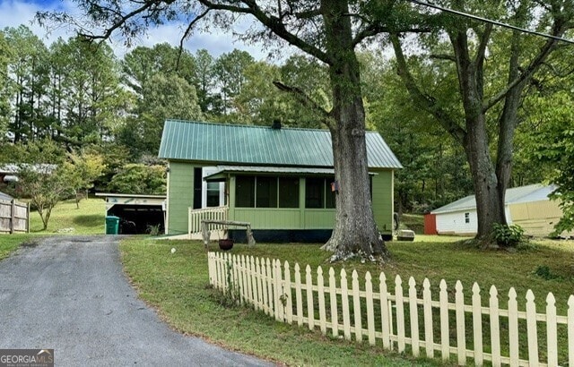 view of front of property with a front lawn and an outdoor structure