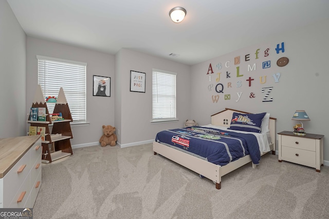 bedroom featuring light colored carpet