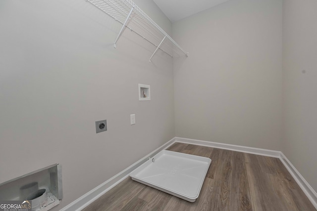 clothes washing area featuring hookup for a gas dryer, hardwood / wood-style flooring, electric dryer hookup, and hookup for a washing machine