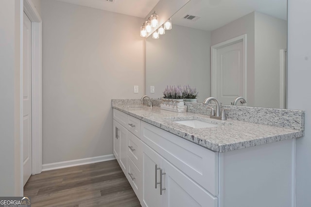 bathroom with vanity and hardwood / wood-style flooring