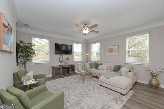 living room featuring ceiling fan, ornamental molding, and hardwood / wood-style floors