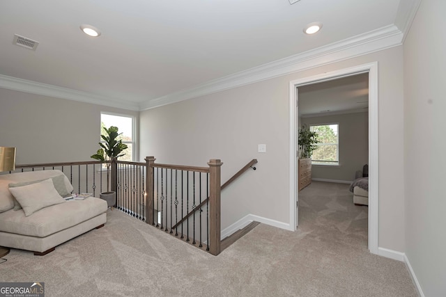 corridor with crown molding and light colored carpet